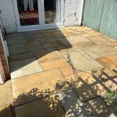 Natural stone patio slabs outside french doors Woking