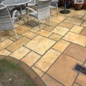 Sandstone patio installation with seating area Woking